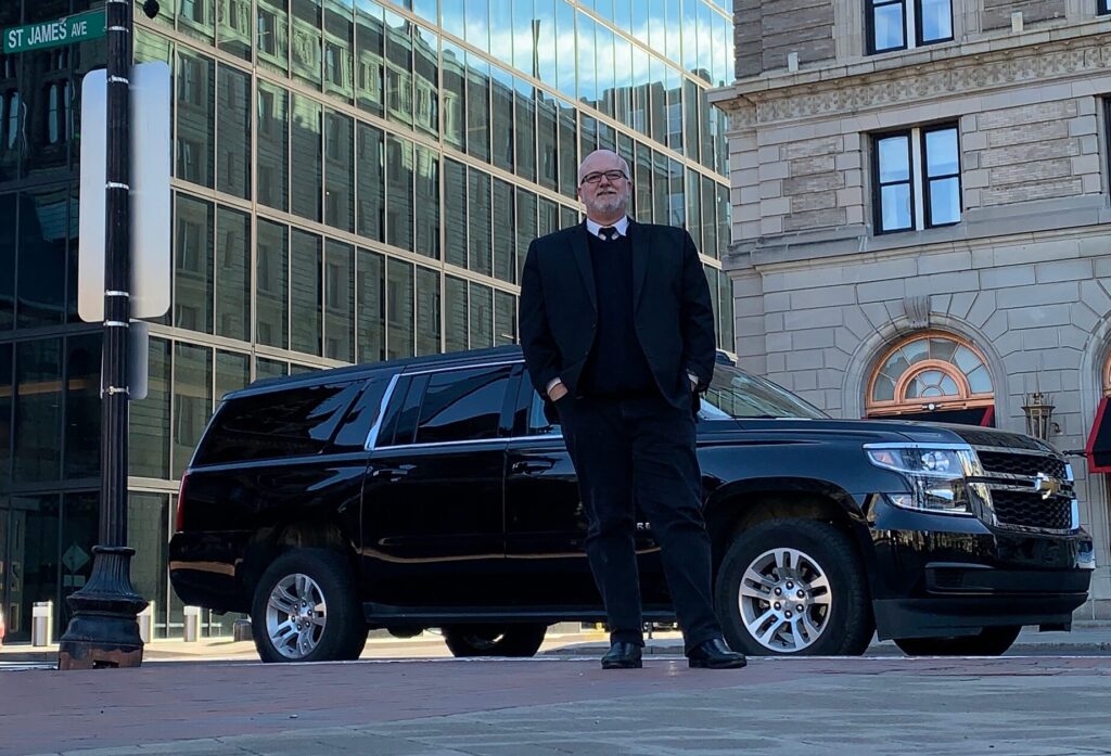 Professional Boston Preferred Car Service chauffeur with luxury SUV in Boston
